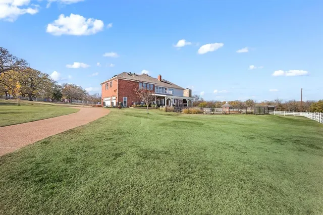 a view of a swimming pool with a yard