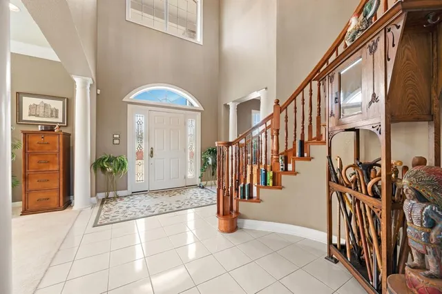 a dining room with furniture a chandelier and wooden floor