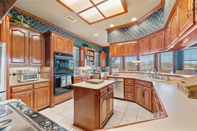 a kitchen with stainless steel appliances granite countertop a sink and cabinets
