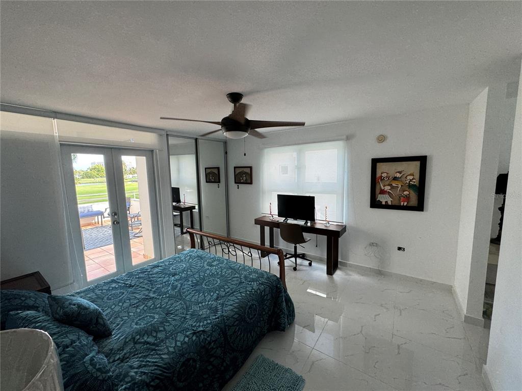 Villas De Golf East Villas De Golf East Dorado Del Mar Boulevard, Unit 91 Dorado, PR 00646 - Photo 11 of 15 a bedroom with a bed and a flat screen tv