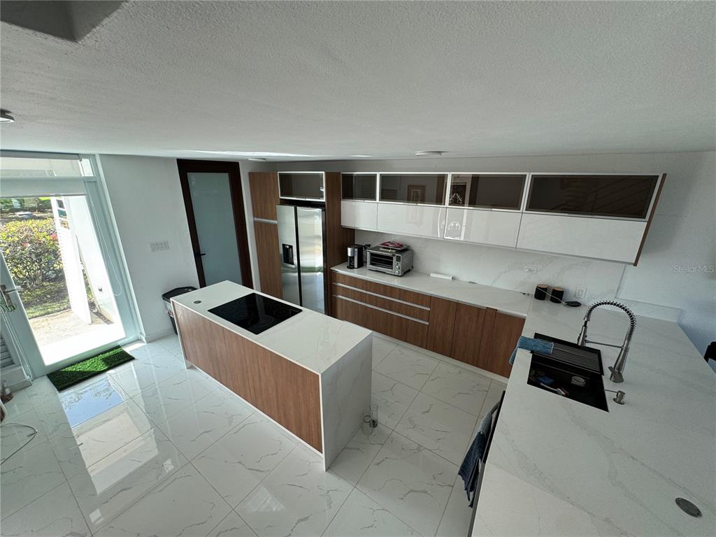 Villas De Golf East Villas De Golf East Dorado Del Mar Boulevard, Unit 91 Dorado, PR 00646 - Photo 4 of 15 a kitchen with stainless steel appliances kitchen island a stove a sink and a refrigerator