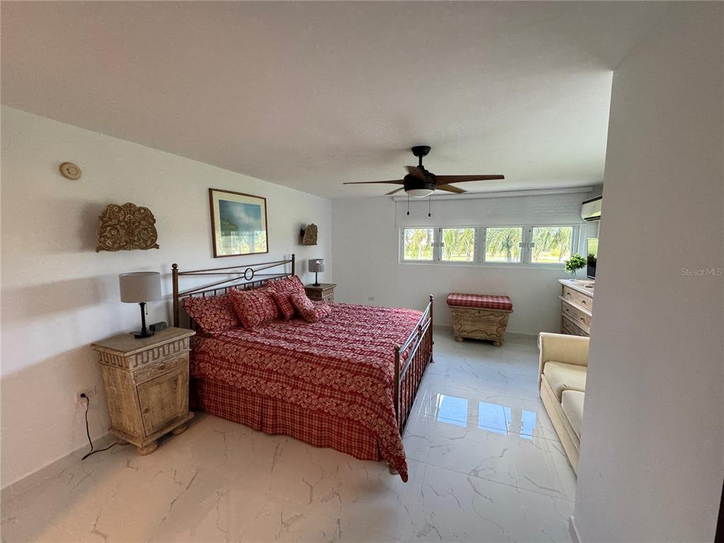 Villas De Golf East Villas De Golf East Dorado Del Mar Boulevard, Unit 91 Dorado, PR 00646 - Photo 10 of 15 a bedroom with bed couch and window