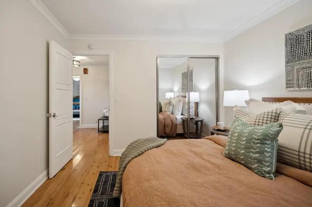 a bedroom with a bed and a chandelier