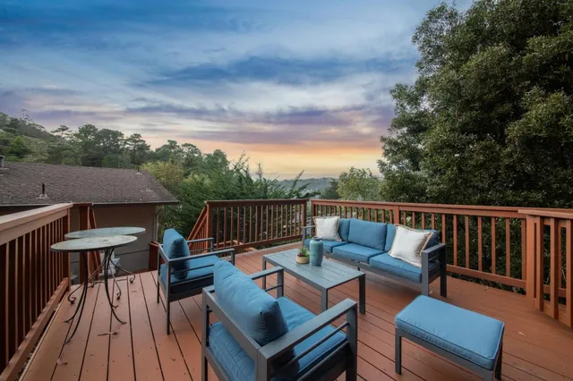 a balcony with wooden floor and furniture