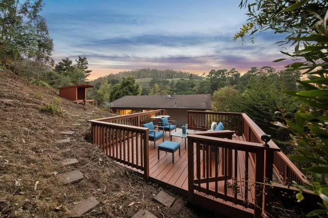 a view of balcony with wooden floor and fence