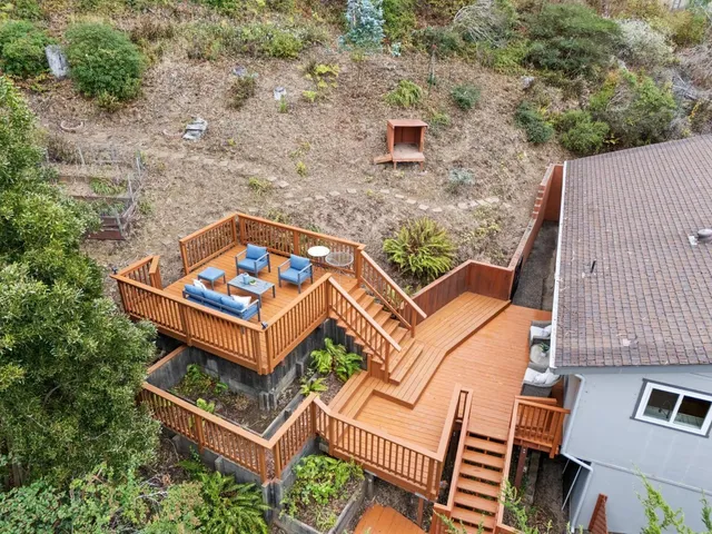 an aerial view of a house with a backyard