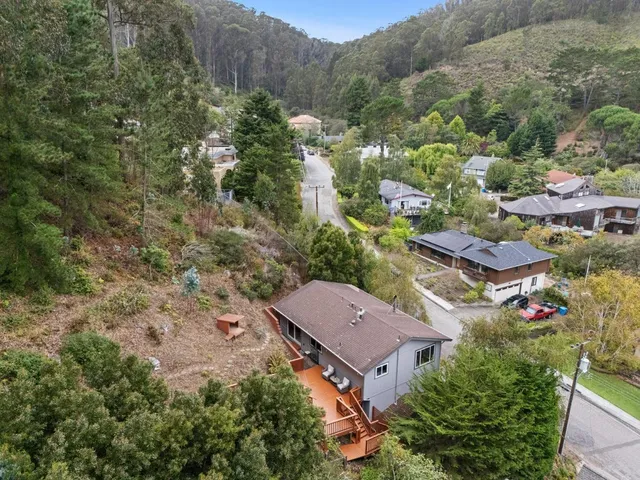 an aerial view of multiple houses with yard