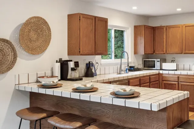 a kitchen with a dining table and chairs