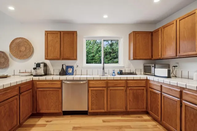 a kitchen with sink cabinets and window
