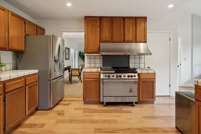 a kitchen with a refrigerator stove and cabinets