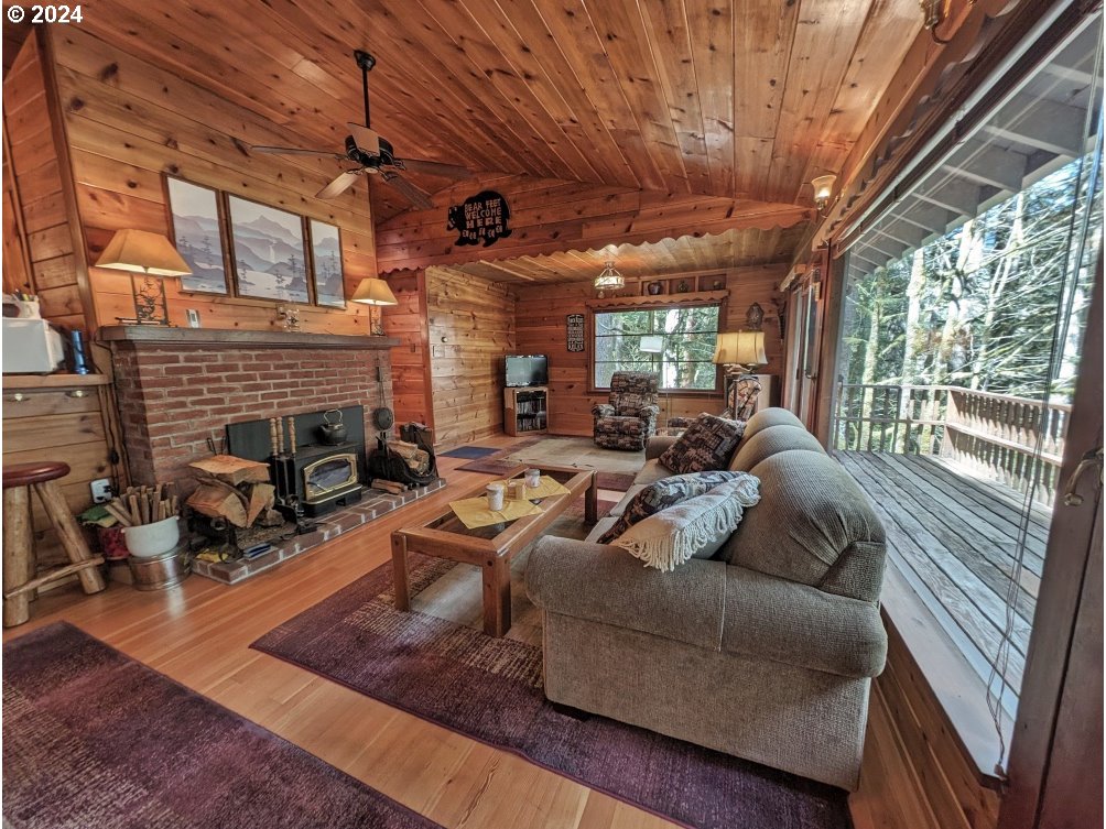 28580 Still Creek Road Rhododendron, OR 97049 - Photo 15 of 40 a living room with furniture and a fireplace
