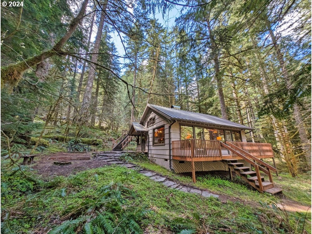28580 Still Creek Road Rhododendron, OR 97049 - Photo 31 of 40 a backyard of a house with wooden deck and tree