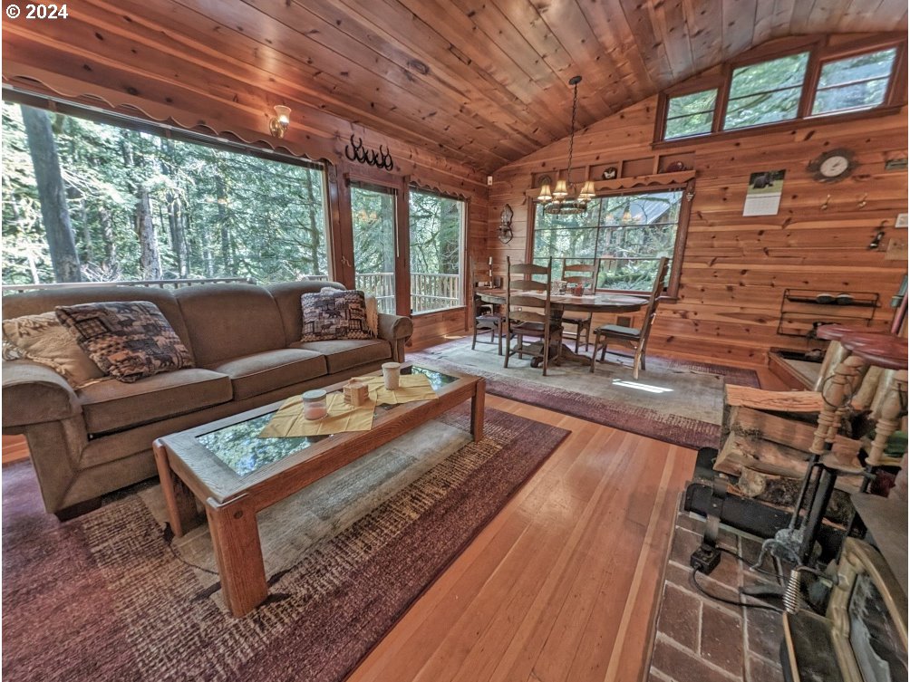 28580 Still Creek Road Rhododendron, OR 97049 - Photo 10 of 40 a living room with furniture a wooden floor and next to a window
