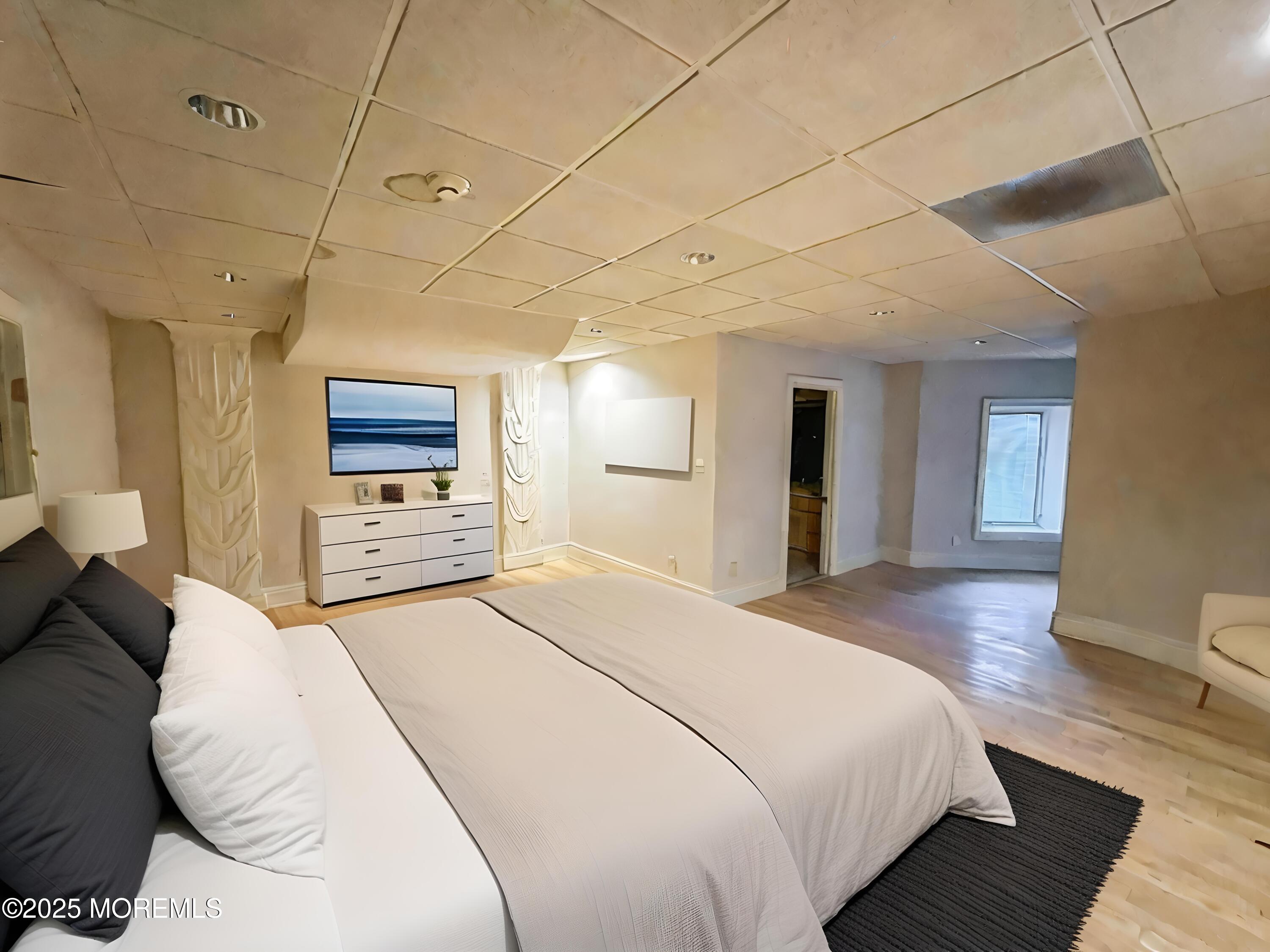 105 Middletown Road Holmdel, NJ 07733 - Photo 10 of 54 a spacious bedroom with a bed and a flat screen tv