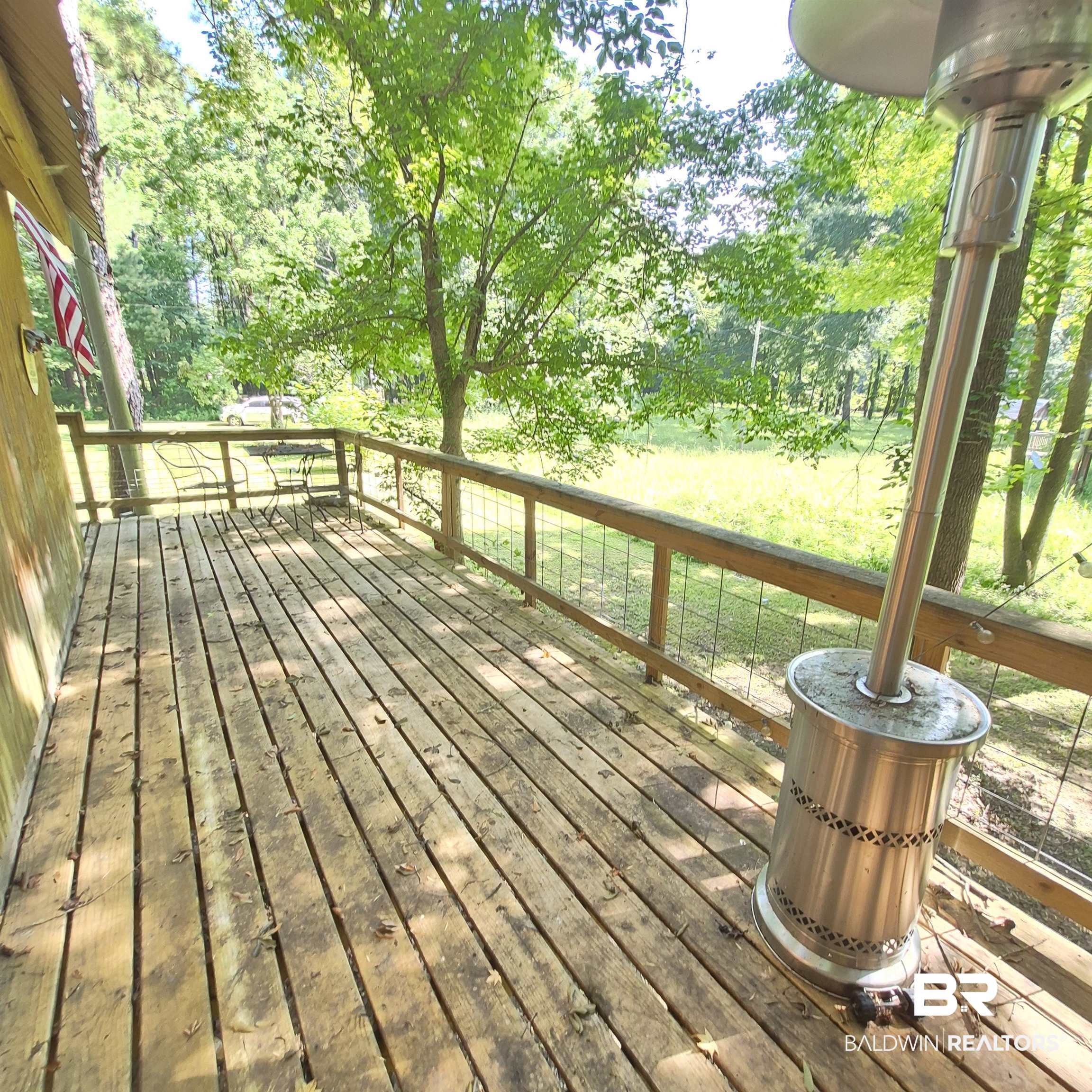 0 Eureka Landing Road Uriah, AL 36480 - Photo 5 of 27 Expansive wood deck with a natural finish, featuring a wooden railing with wire infill