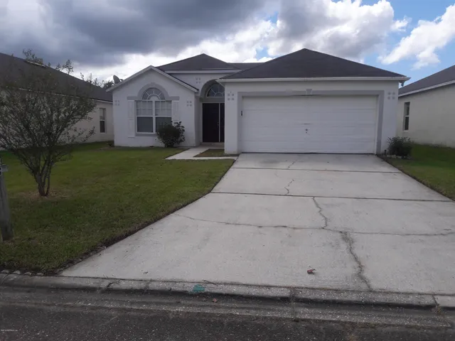a front view of house with a garden