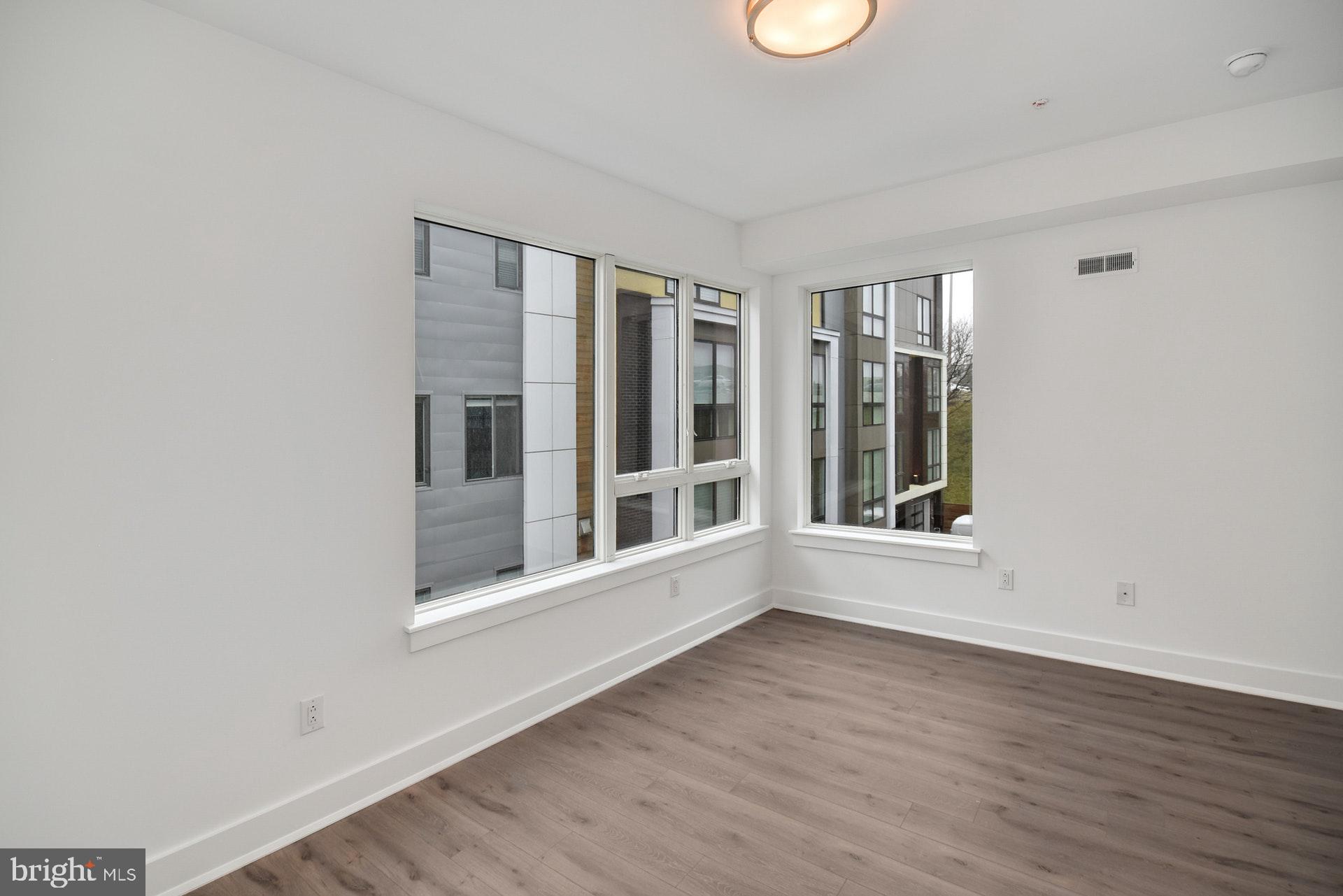 113 Olive Street Philadelphia, PA 19123 - Photo 15 of 33 a view of an empty room with wooden floor and a window