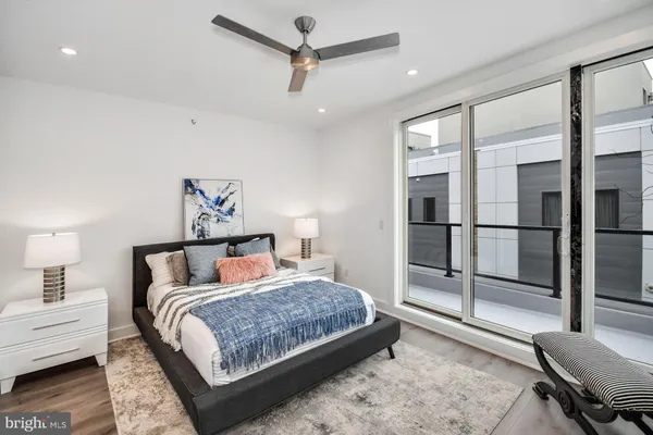 a bedroom with a large bed and a chandelier