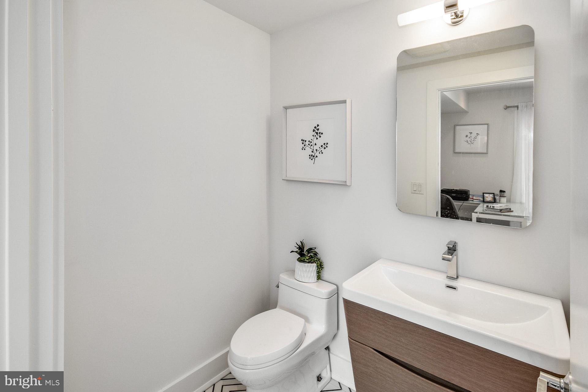 113 Olive Street Philadelphia, PA 19123 - Photo 5 of 33 a bathroom with a toilet a sink and mirror