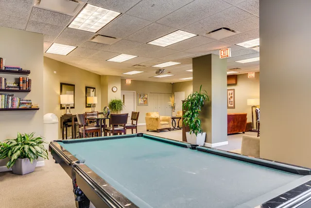 a living room with furniture and potted plants