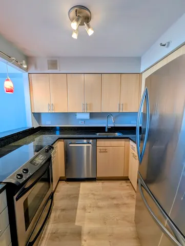 a kitchen with a stove and a refrigerator