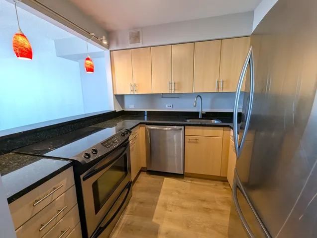 a view of kitchen and wooden floor