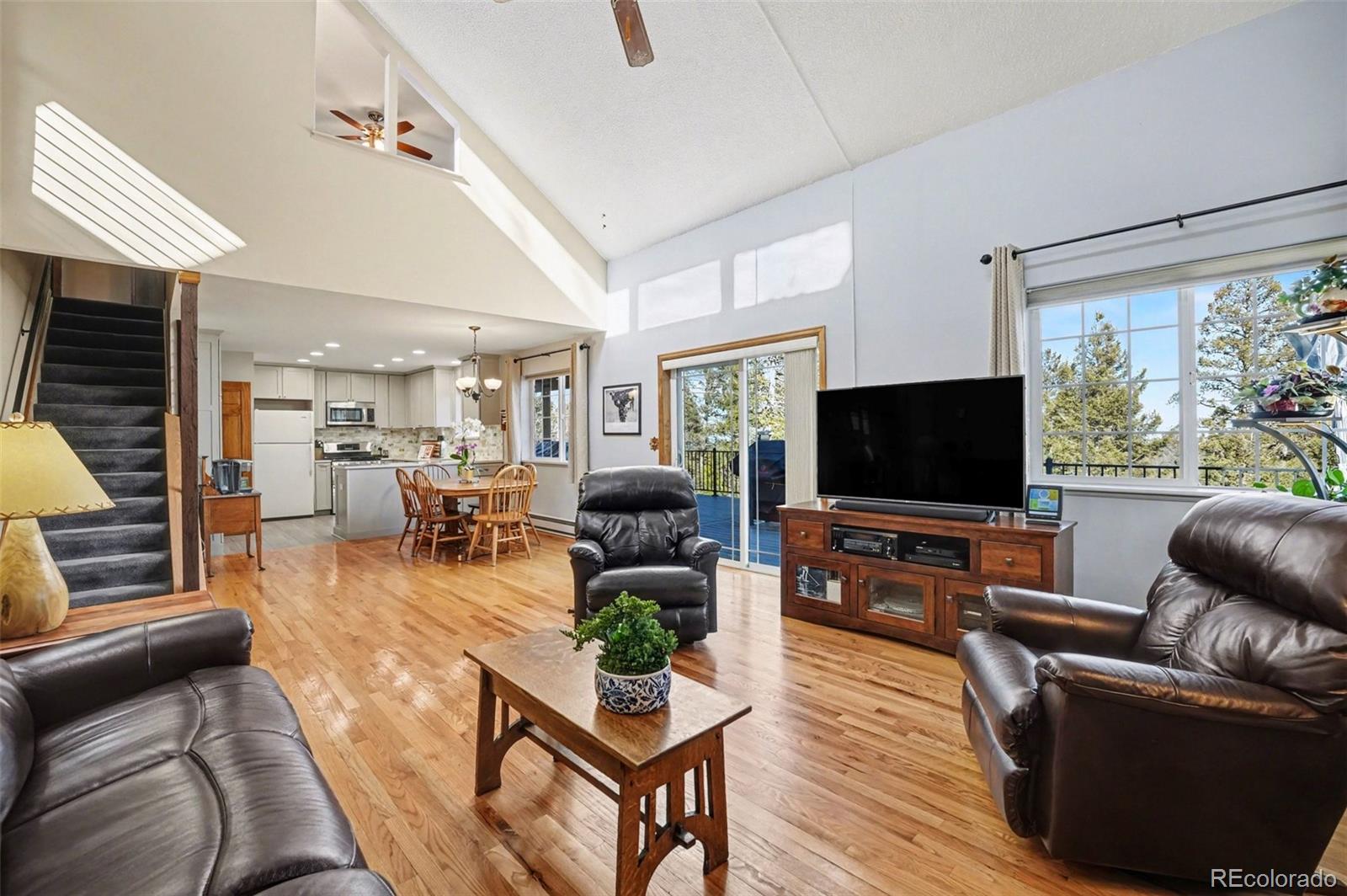 9780 South Warhawk Road Conifer, CO 80433 - Photo 13 of 44 a living room with furniture and a flat screen tv