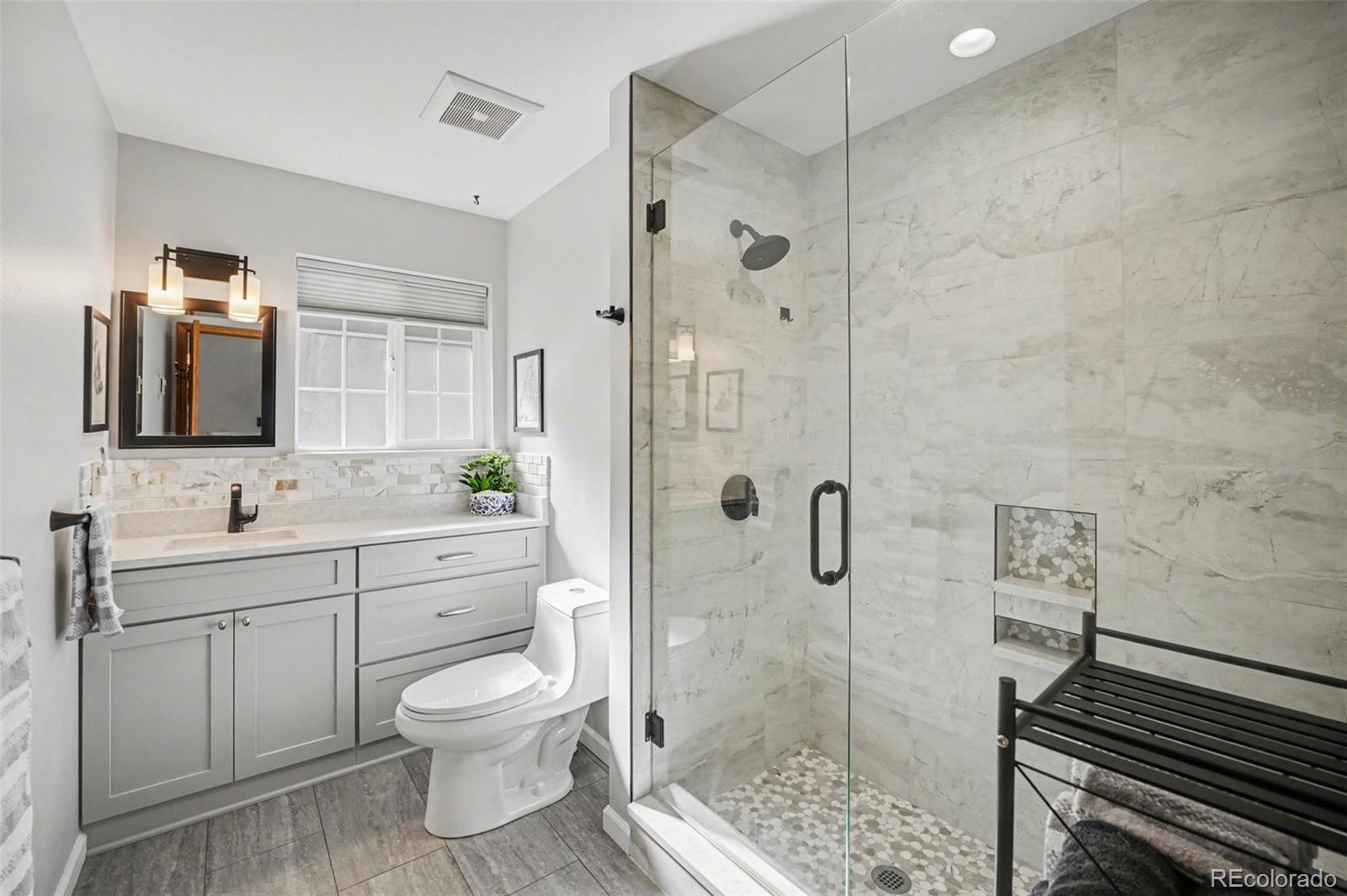 9780 South Warhawk Road Conifer, CO 80433 - Photo 14 of 44 a bathroom with a toilet sink a shower and