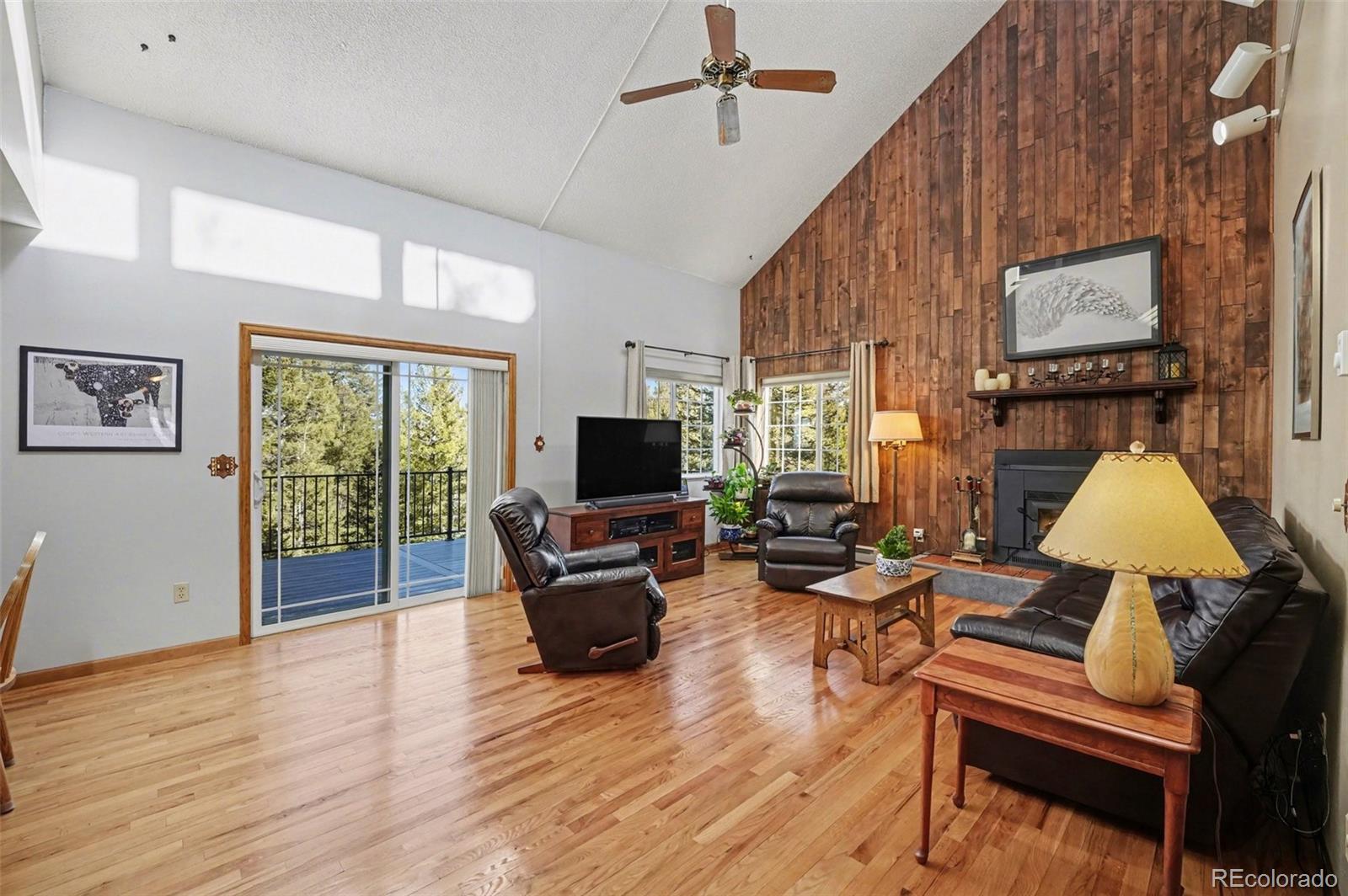 9780 South Warhawk Road Conifer, CO 80433 - Photo 2 of 44 a living room with furniture and a flat screen tv