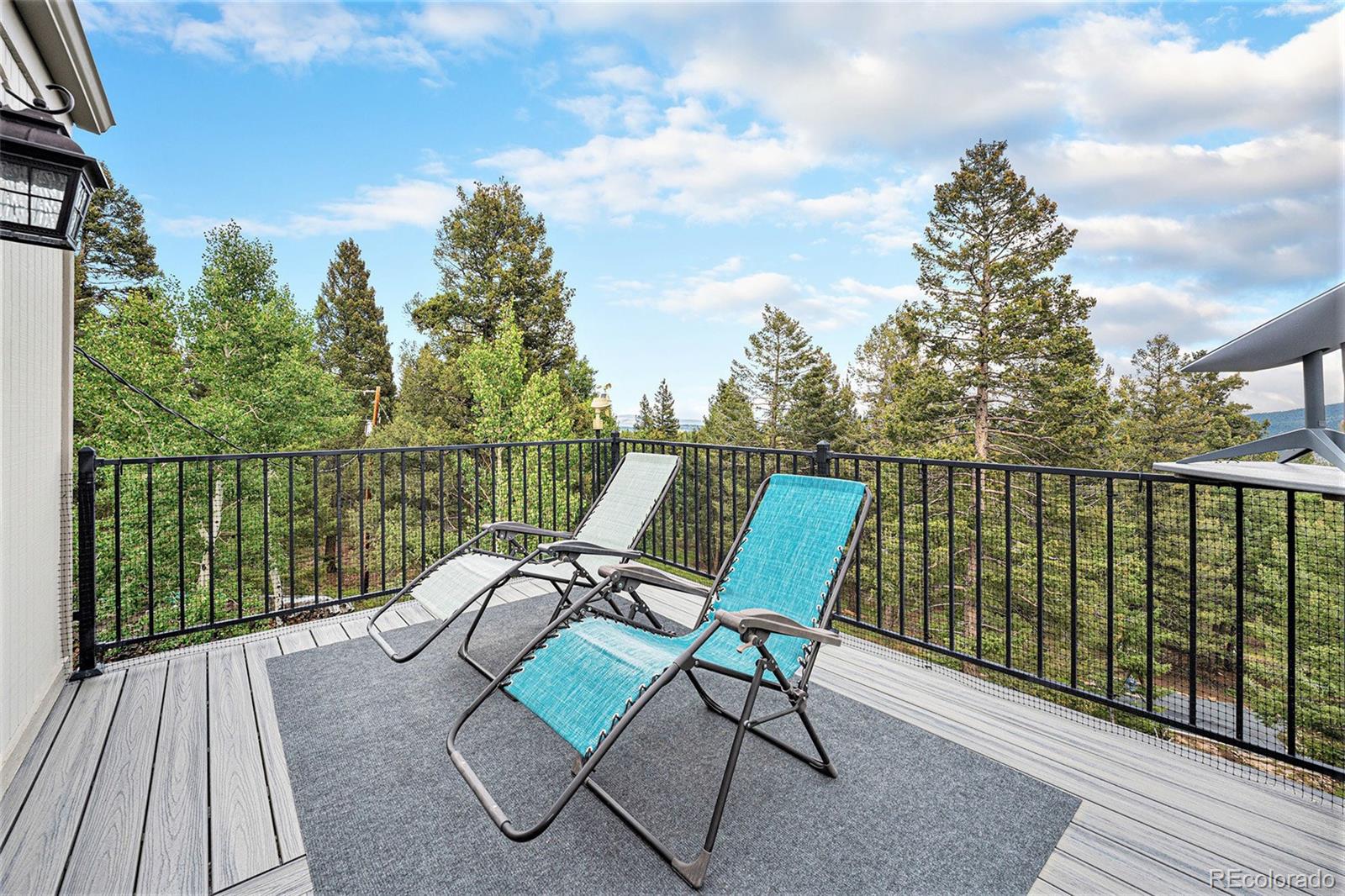 9780 South Warhawk Road Conifer, CO 80433 - Photo 21 of 44 a view of a chairs in wooden deck