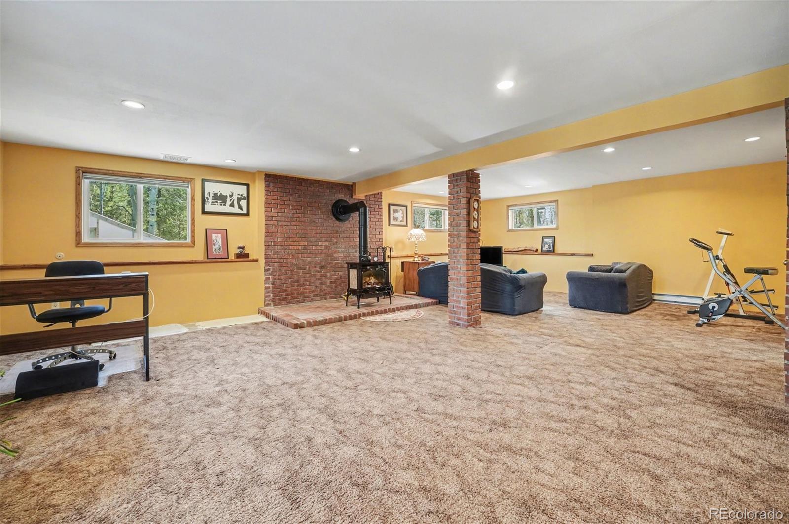 9780 South Warhawk Road Conifer, CO 80433 - Photo 26 of 44 a bed room with furniture and a flat screen tv