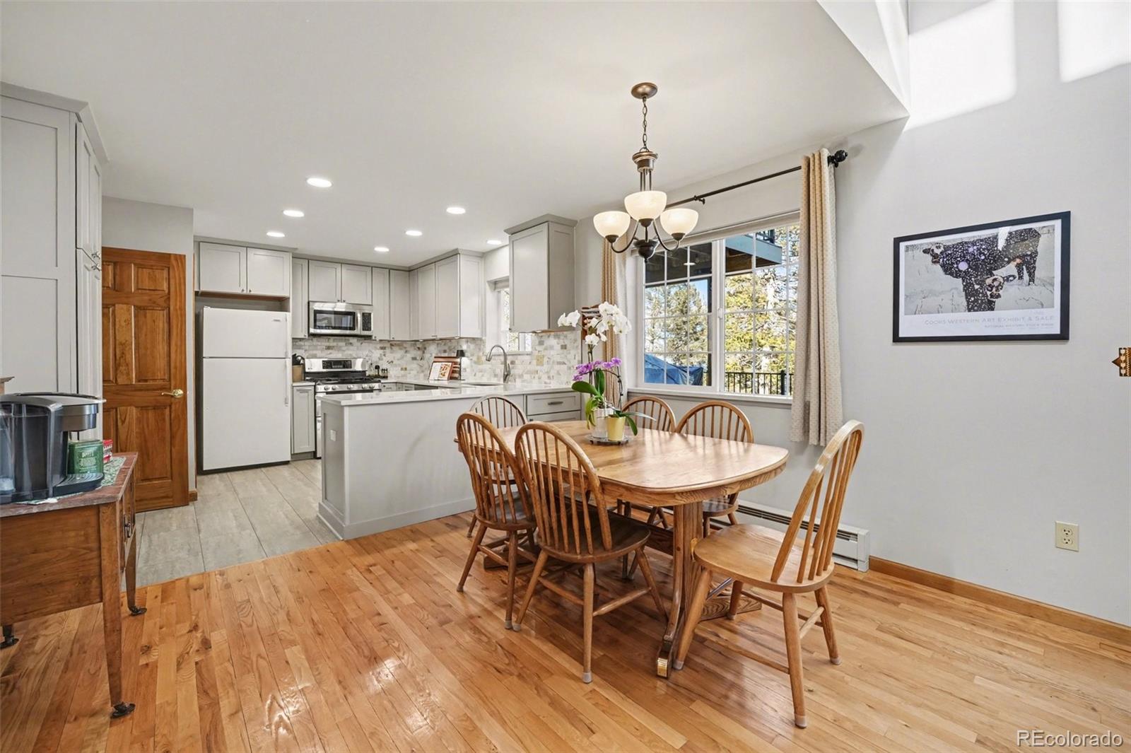 9780 South Warhawk Road Conifer, CO 80433 - Photo 3 of 44 a view of a dining room with furniture large window and wooden floor