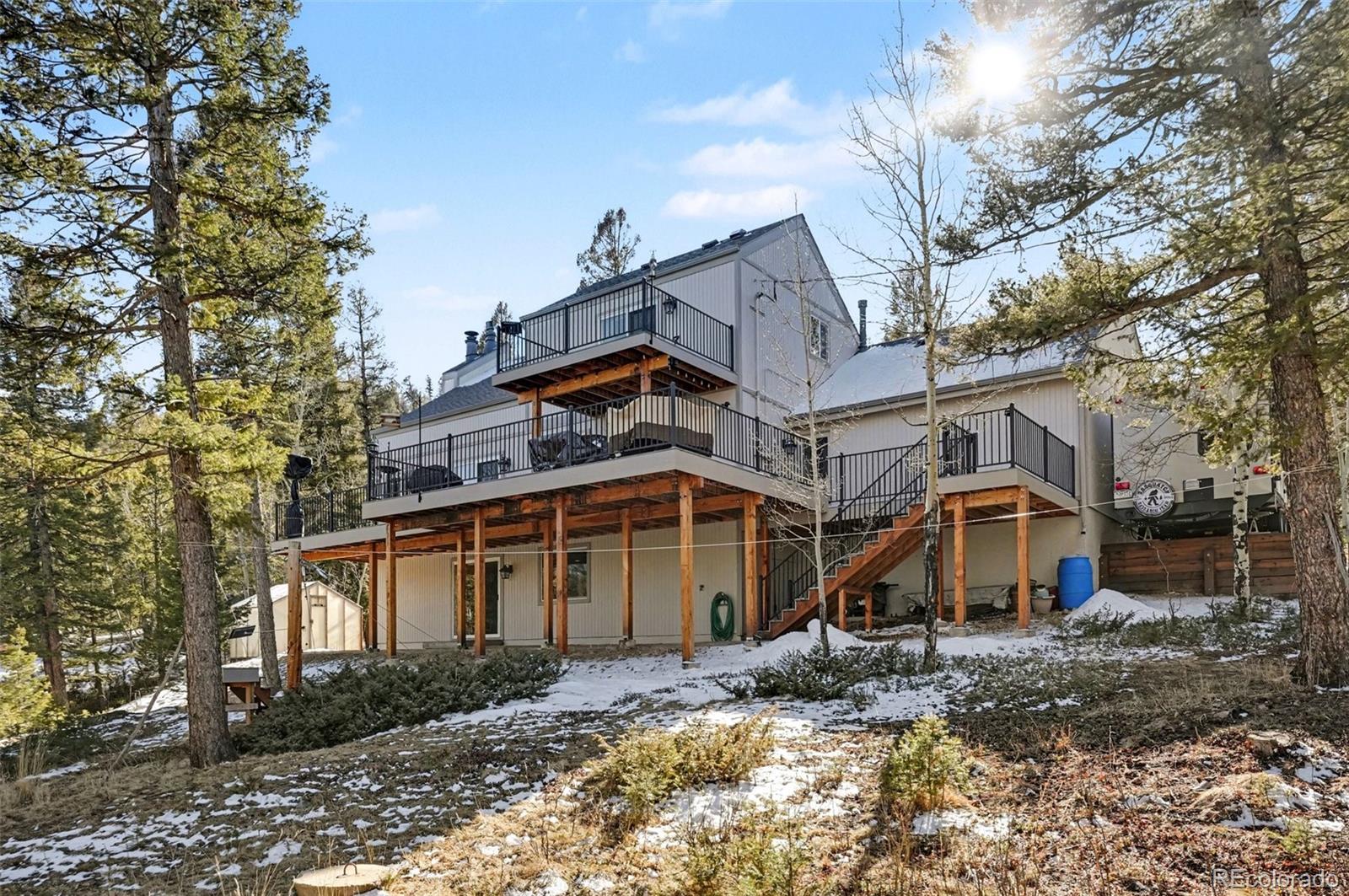 9780 South Warhawk Road Conifer, CO 80433 - Photo 34 of 44 a view of a house with a yard