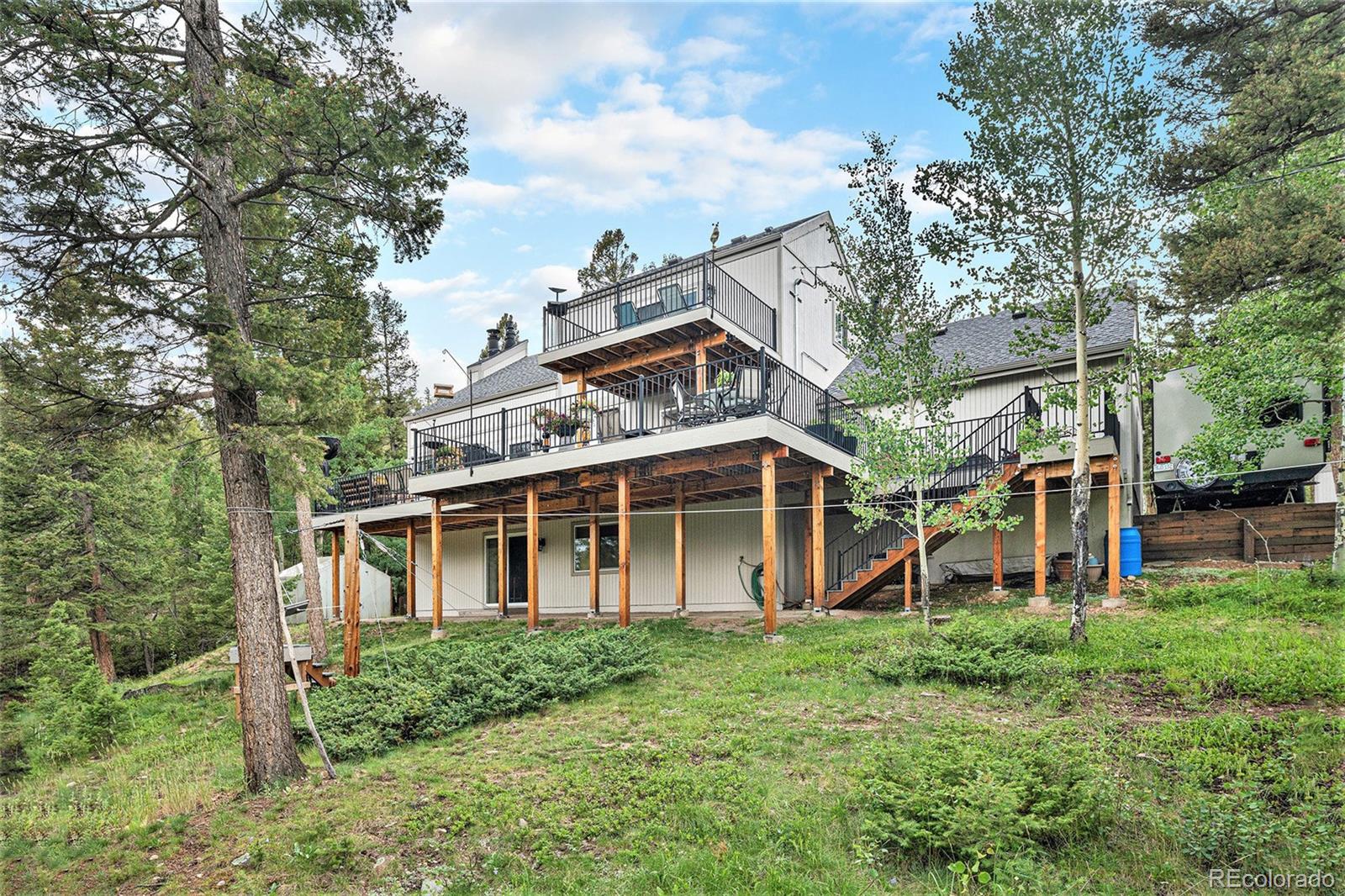 9780 South Warhawk Road Conifer, CO 80433 - Photo 35 of 44 aerial view of a house with a yard and potted plants