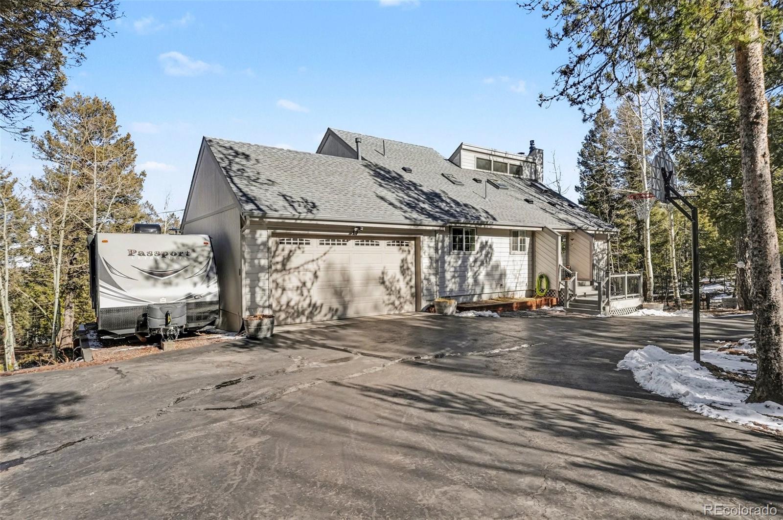 9780 South Warhawk Road Conifer, CO 80433 - Photo 42 of 44 a view of a house with a large space and a car park in front of it