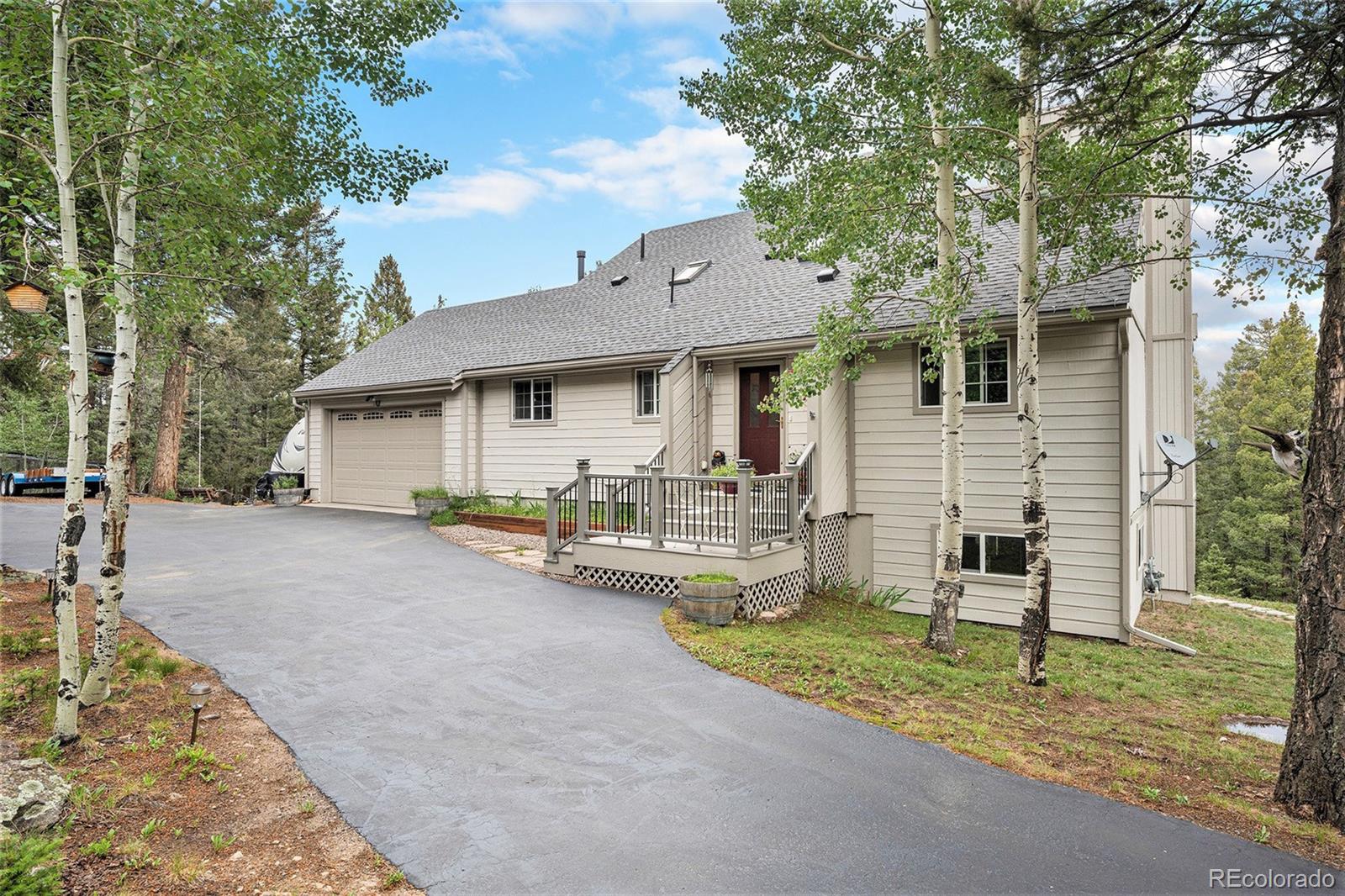 9780 South Warhawk Road Conifer, CO 80433 - Photo 43 of 44 a view of a house with backyard and a tree