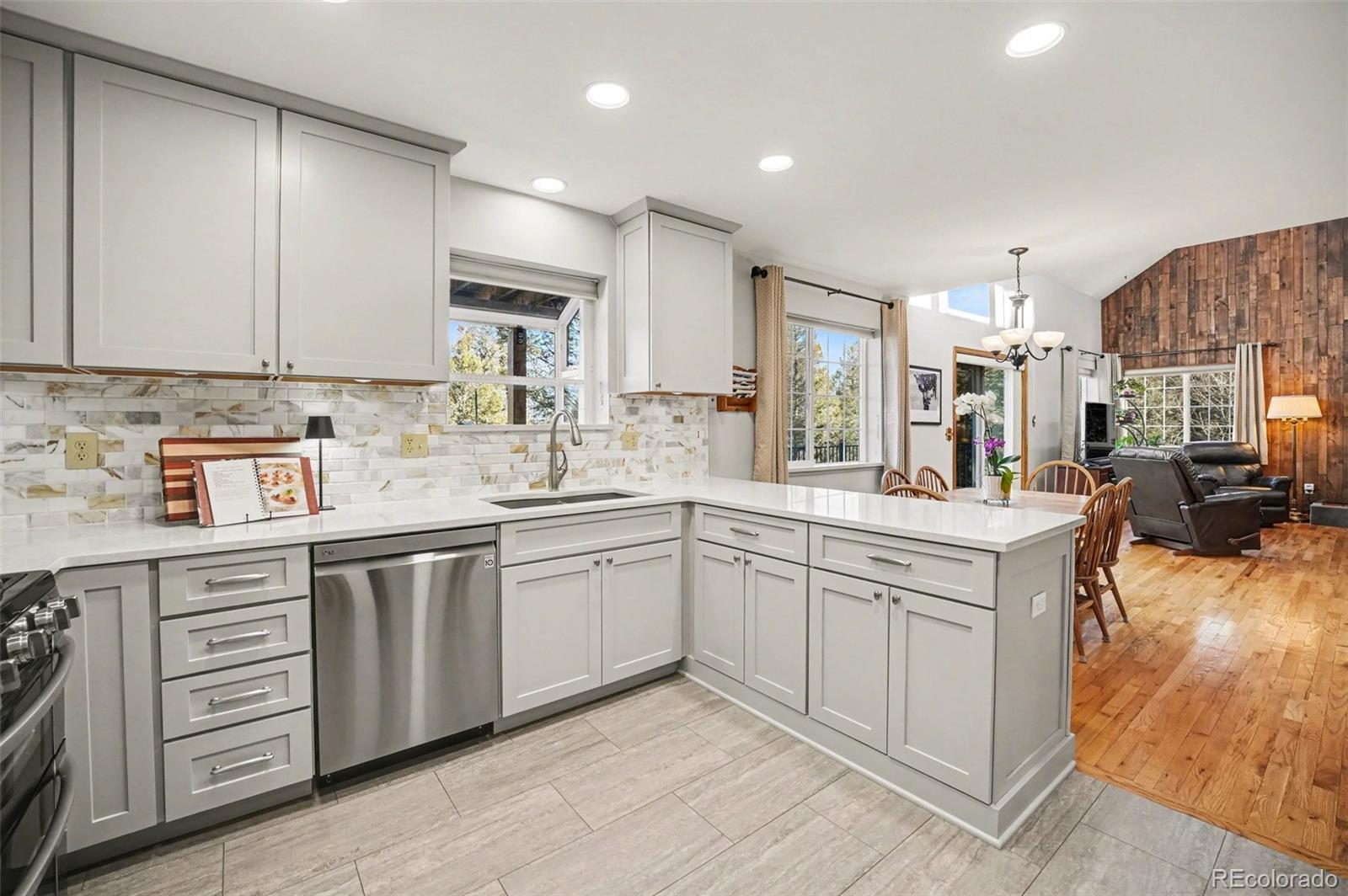 9780 South Warhawk Road Conifer, CO 80433 - Photo 5 of 44 a kitchen with stainless steel appliances granite countertop a sink stove and cabinets