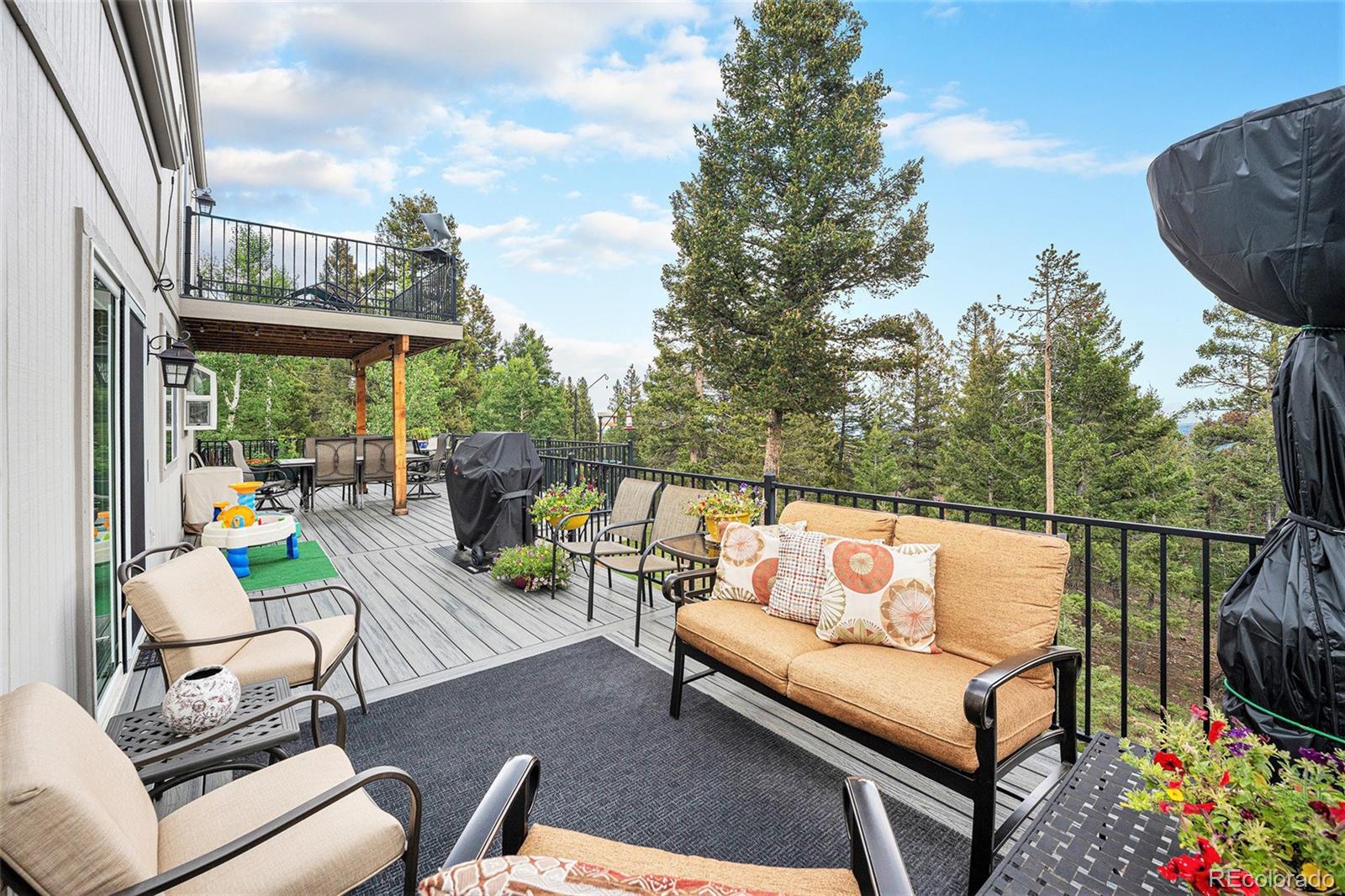 9780 South Warhawk Road Conifer, CO 80433 - Photo 10 of 44 a outdoor living space with furniture and garden view