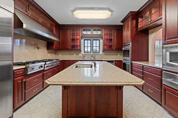 a kitchen with stainless steel appliances granite countertop a sink dishwasher stove and oven