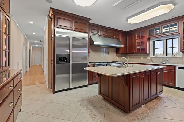 a kitchen with a sink stove and refrigerator