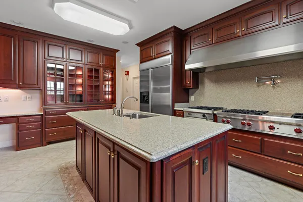 a kitchen with a stove a sink and a refrigerator