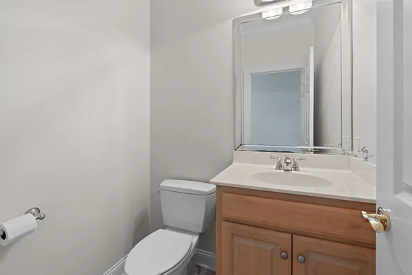 a bathroom with a sink a toilet and mirror