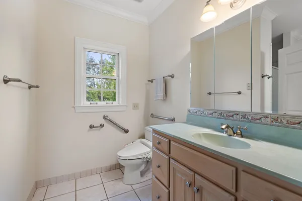 a bathroom with a sink toilet and a mirror