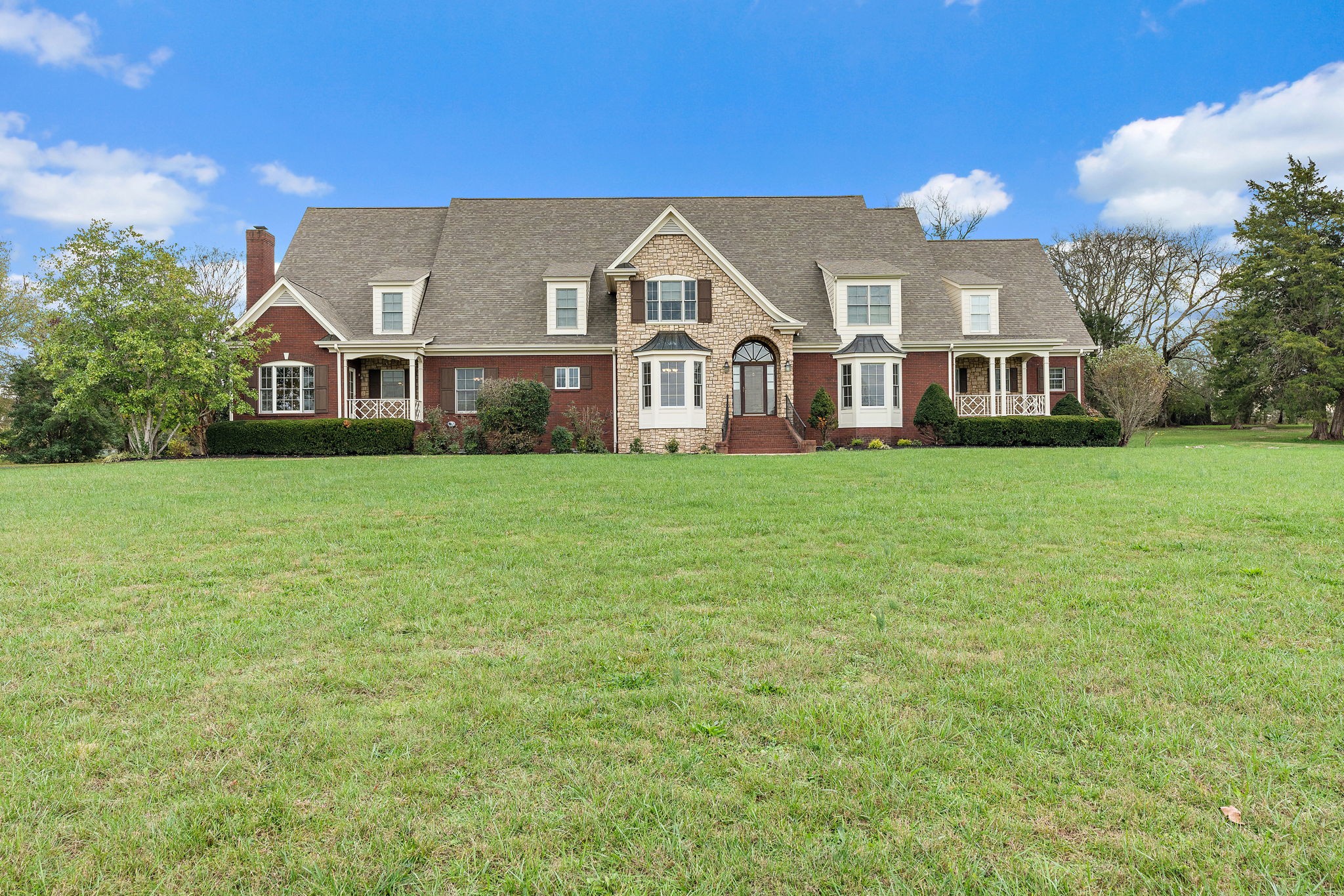 303 Middlefield Lane Lascassas, TN 37085 - Photo 3 of 49 a front view of a house with a garden