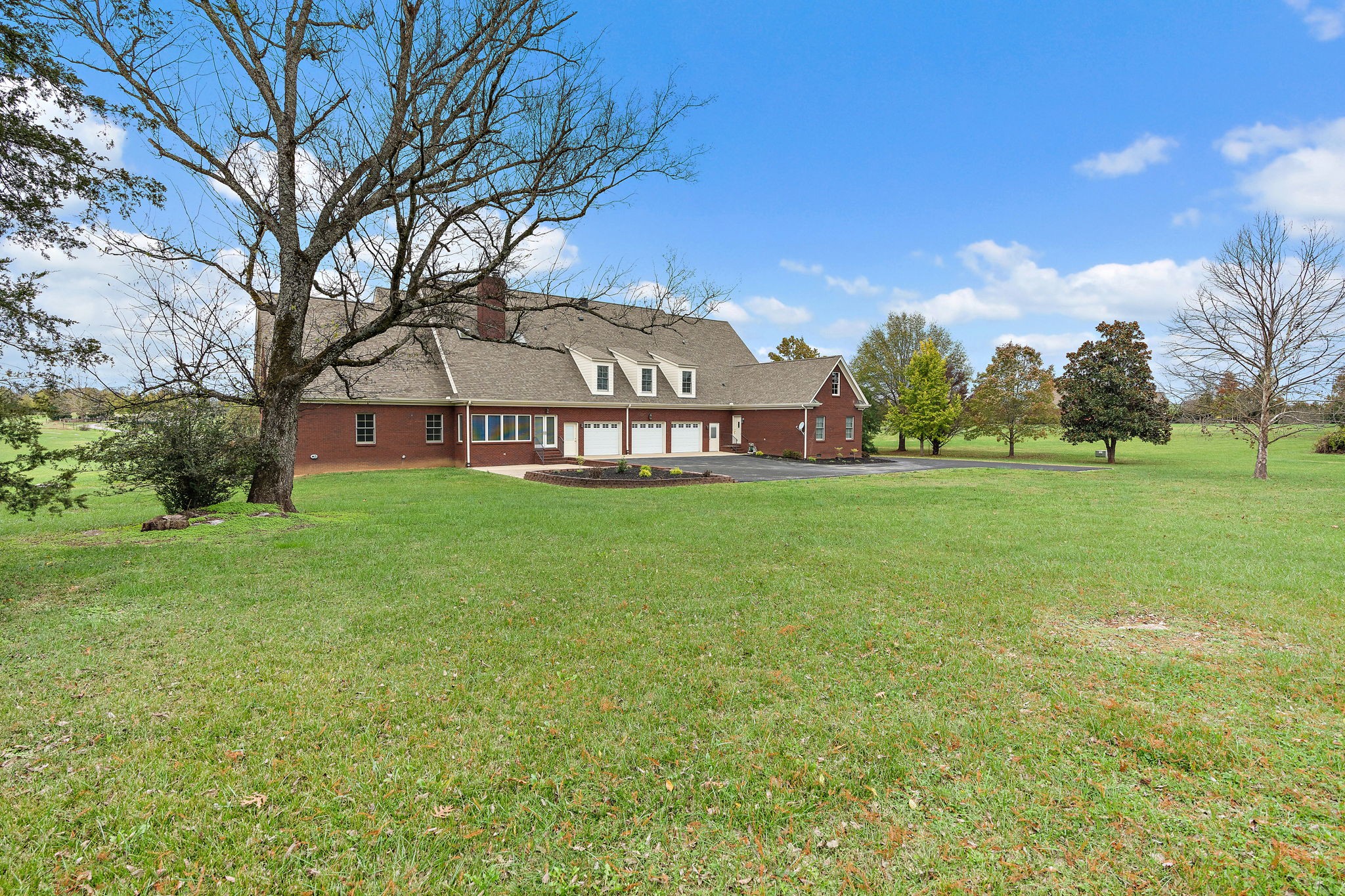 303 Middlefield Lane Lascassas, TN 37085 - Photo 47 of 49 a view of a large garden with plants and large trees