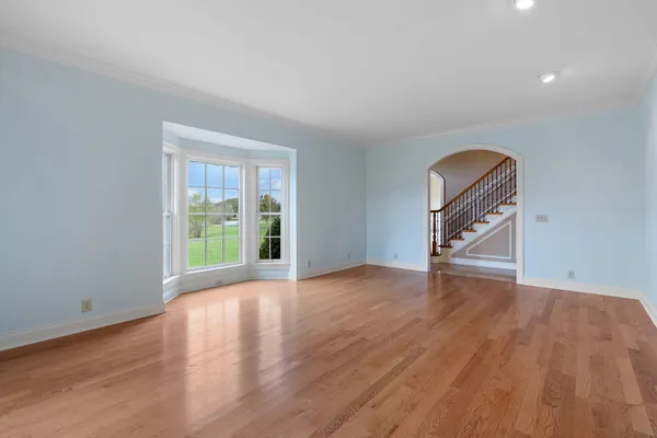 a view of a livingroom with wooden floor and a window