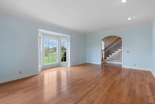 a view of a livingroom with wooden floor and a window