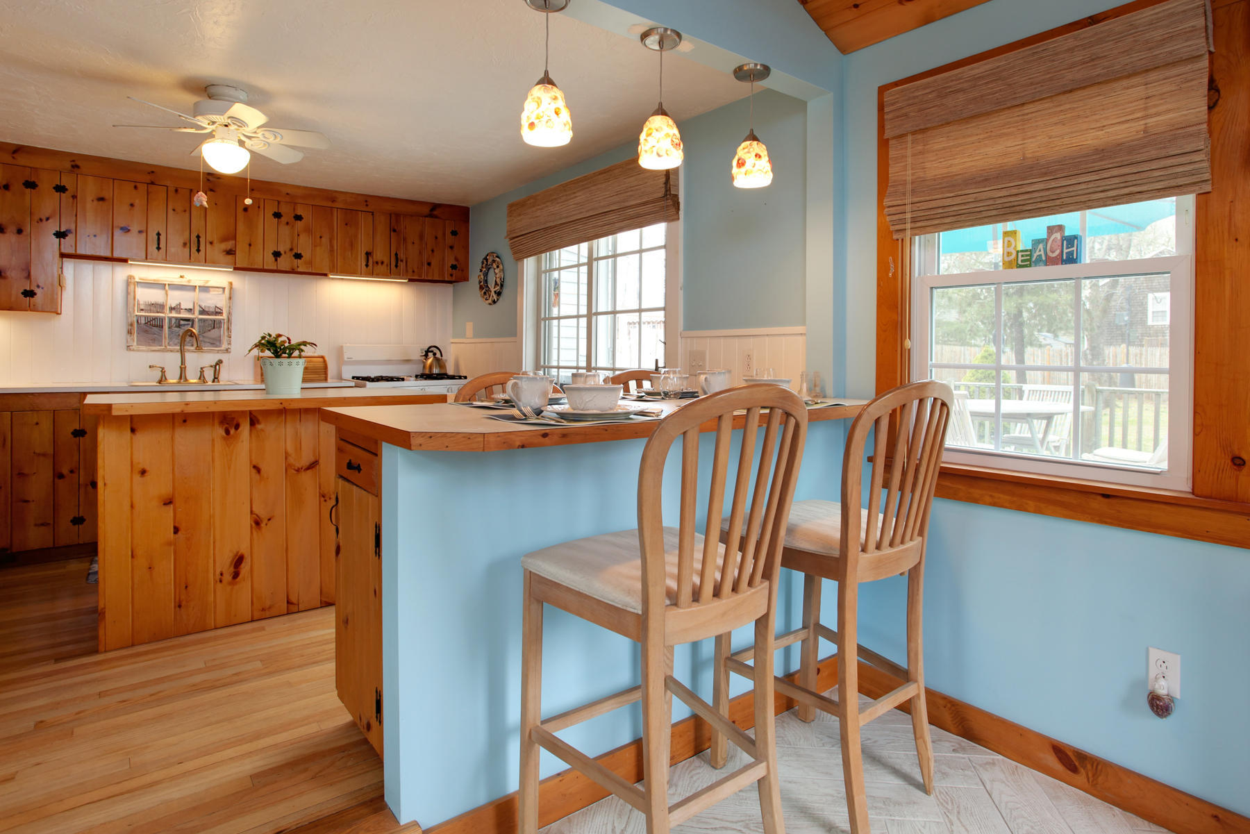 21 Naushon Road Dennis Port, MA 02639 - Photo 13 of 27 a kitchen with a table chairs and wooden floor