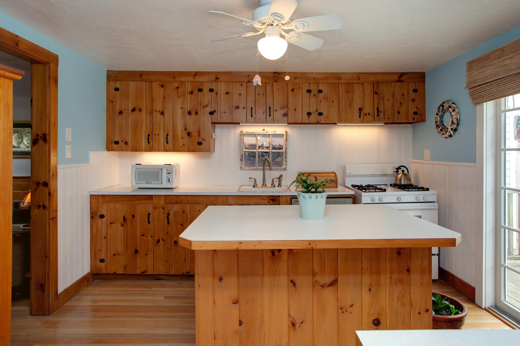 21 Naushon Road Dennis Port, MA 02639 - Photo 8 of 27 a kitchen with stainless steel appliances granite countertop a sink a stove cabinets and wooden floor