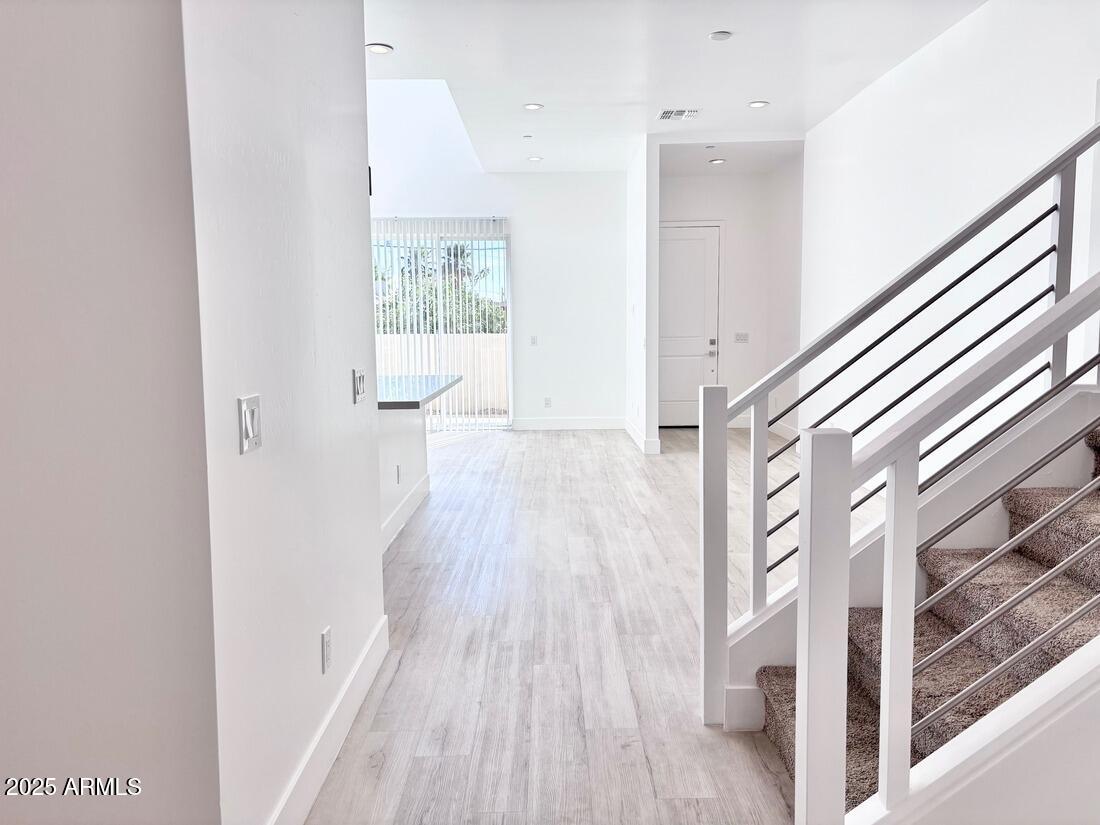 4050 North 12th Street, Unit 6 Phoenix, AZ 85014 - Photo 14 of 50 a view of a hallway with wooden floor and staircase